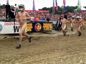 Wild folks wearing a helmet run naked on a cross track