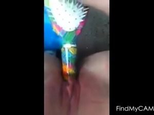Teen fucking herself with hairbrush
